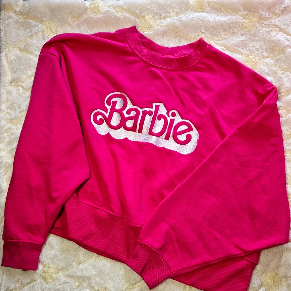 Barbie sweater is M. Is new without tags never worn.